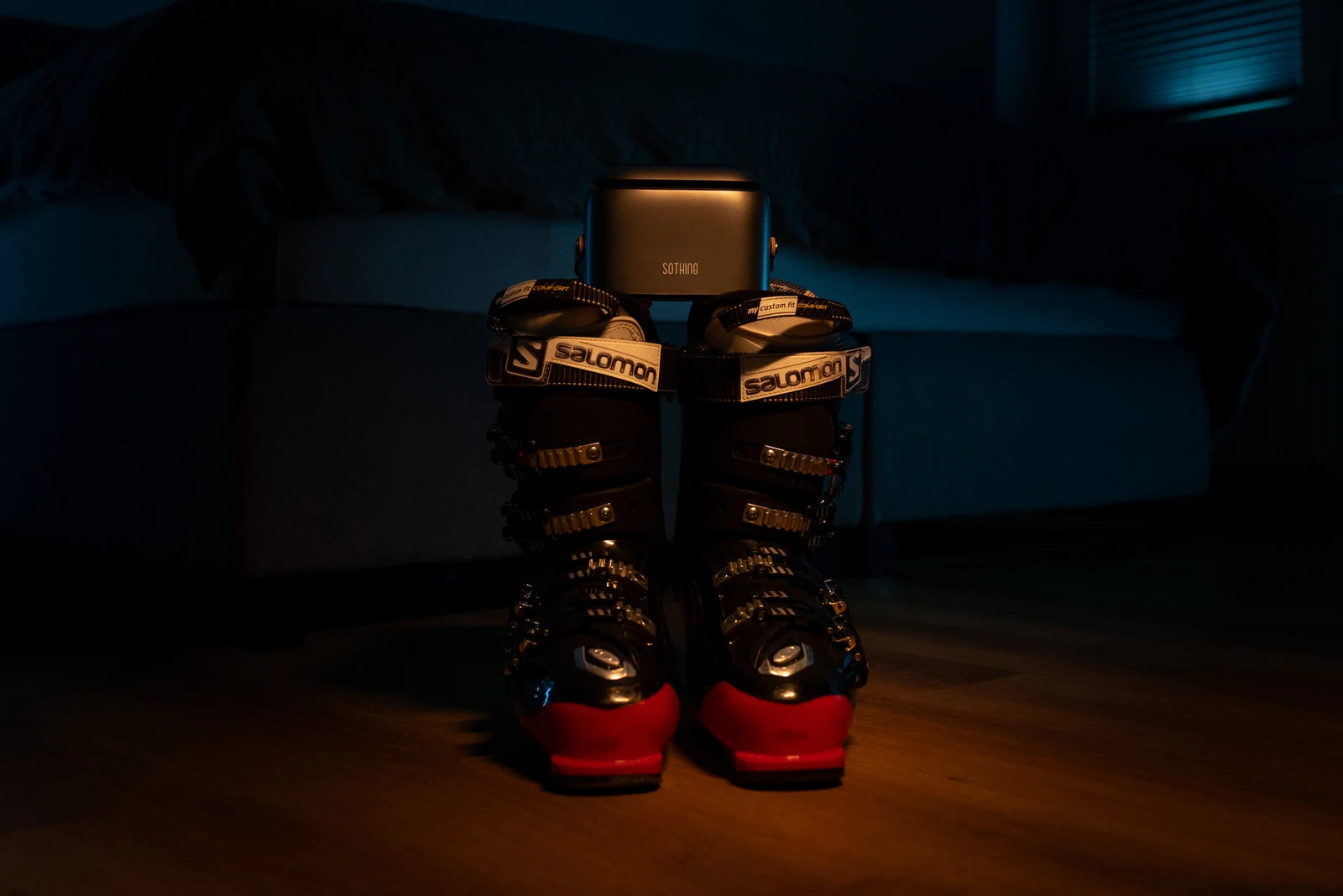 Original evening photograph of Ultra Grey with ski boots in front of a sofa