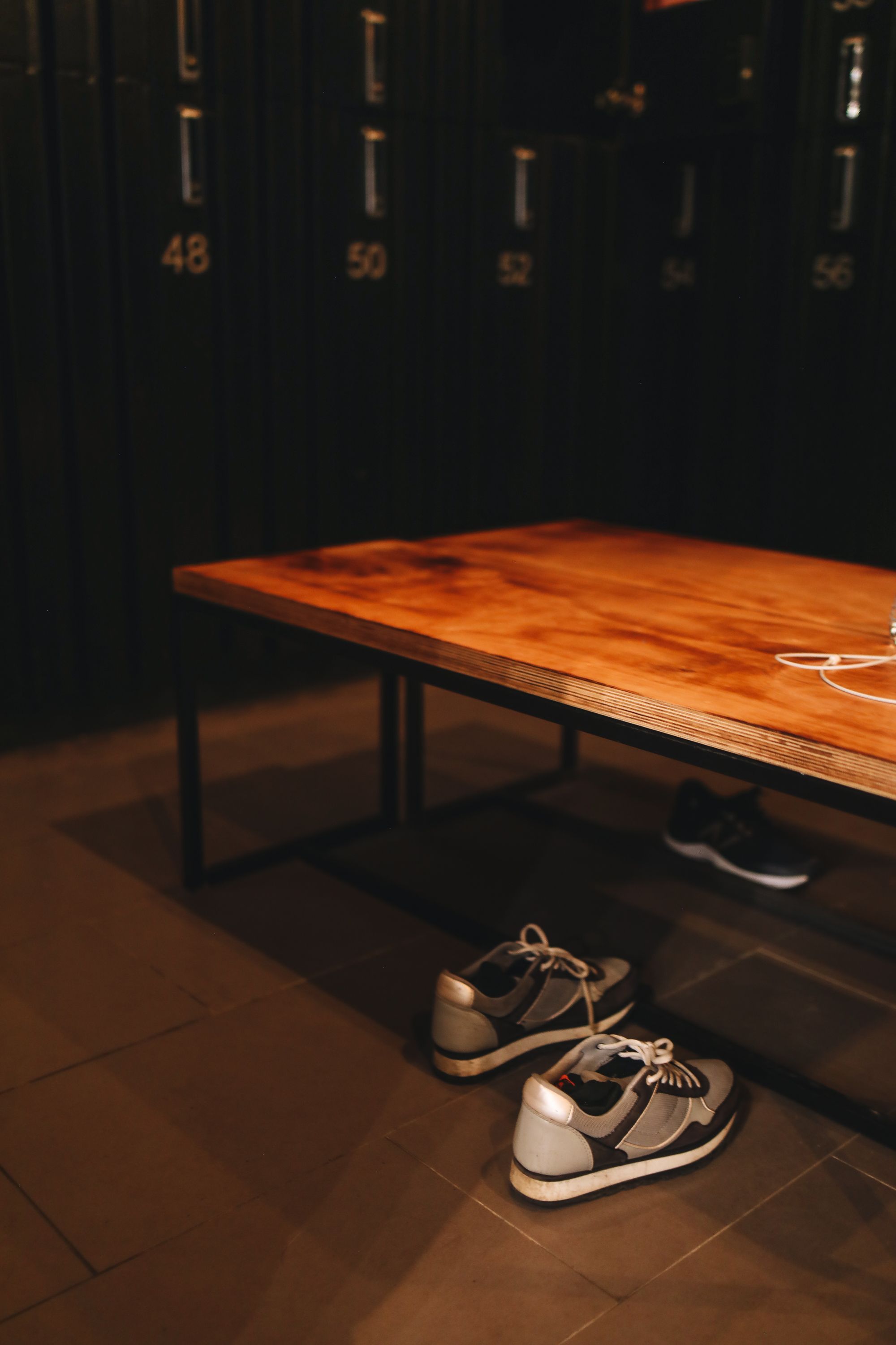 Illustrative photograph of trainers in a locker room; no SOTHING product is depicted